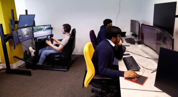 An operator controls a Fetch driverless car during driverless car trials, in Milton Keynes