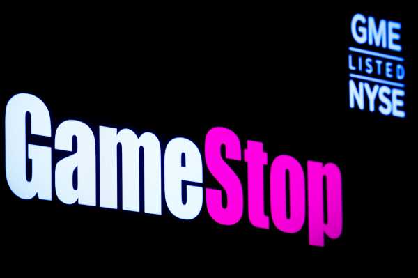 A screen displays the logo and trading information for GameStop at the NYSE  in New York