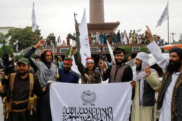 Taliban fighters celebrate the first anniversary of the fall of Kabul